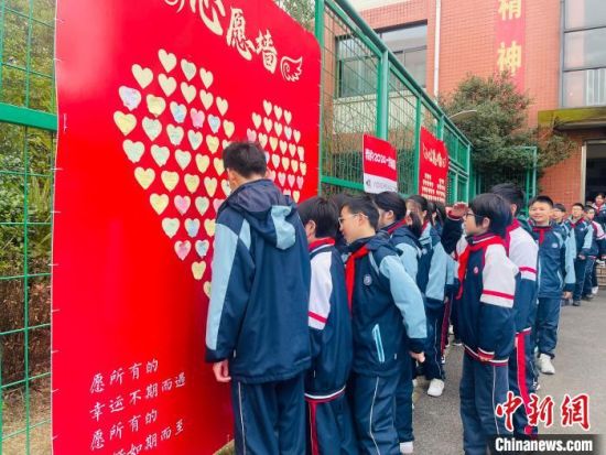 泗塘中学设立心愿墙，学生们精心挑选自己喜欢的心愿卡，一笔一画地写下新年的美好愿望。(宝山区教育局供图)